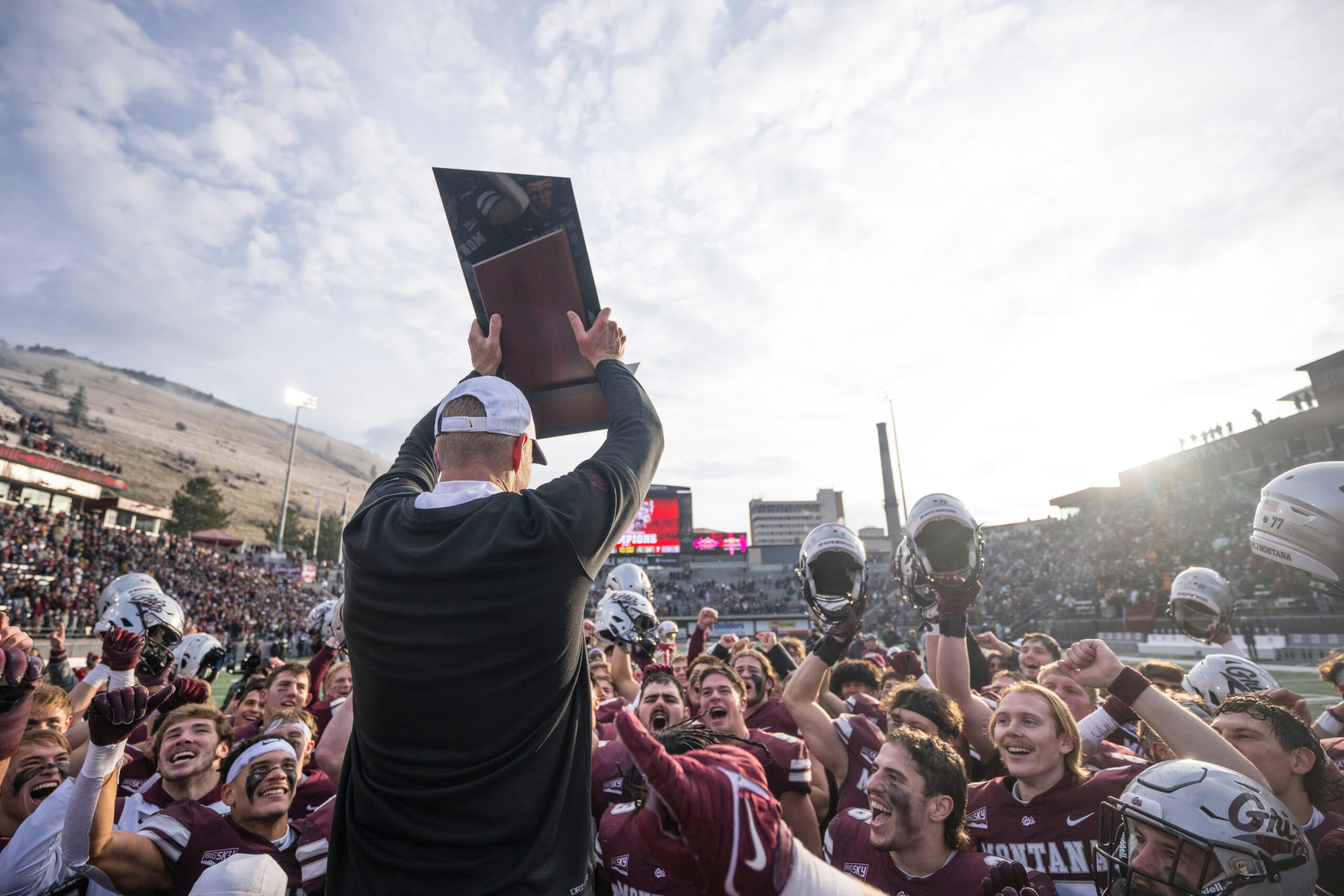 Coach holding a trophy. 